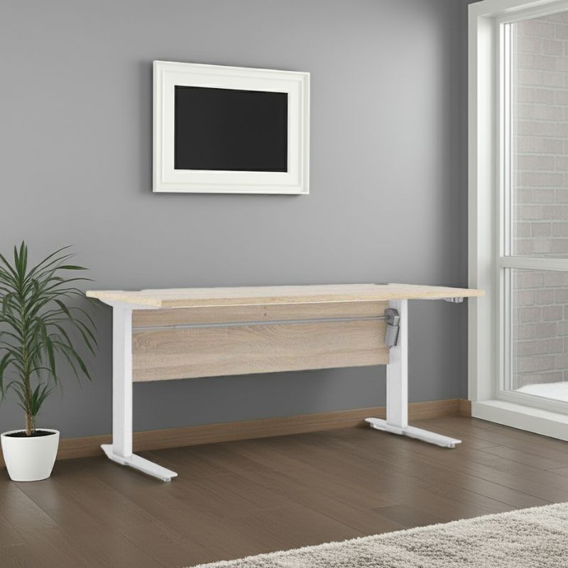 Wooden desk with white legs in a room with a gray wall and a plant.