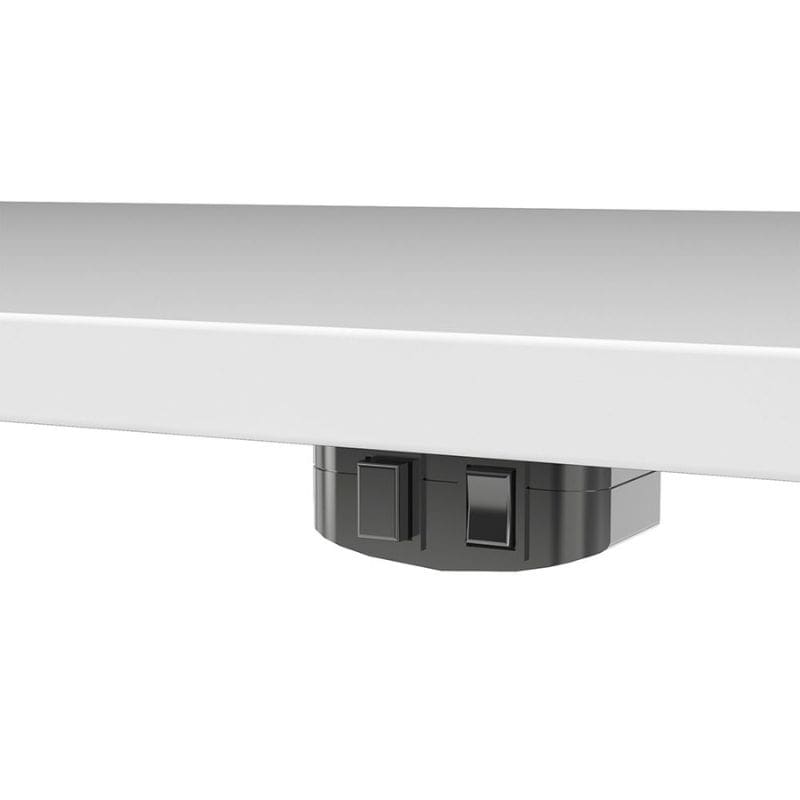 Close-up of a white surface with a black electrical outlet and switch on a white background