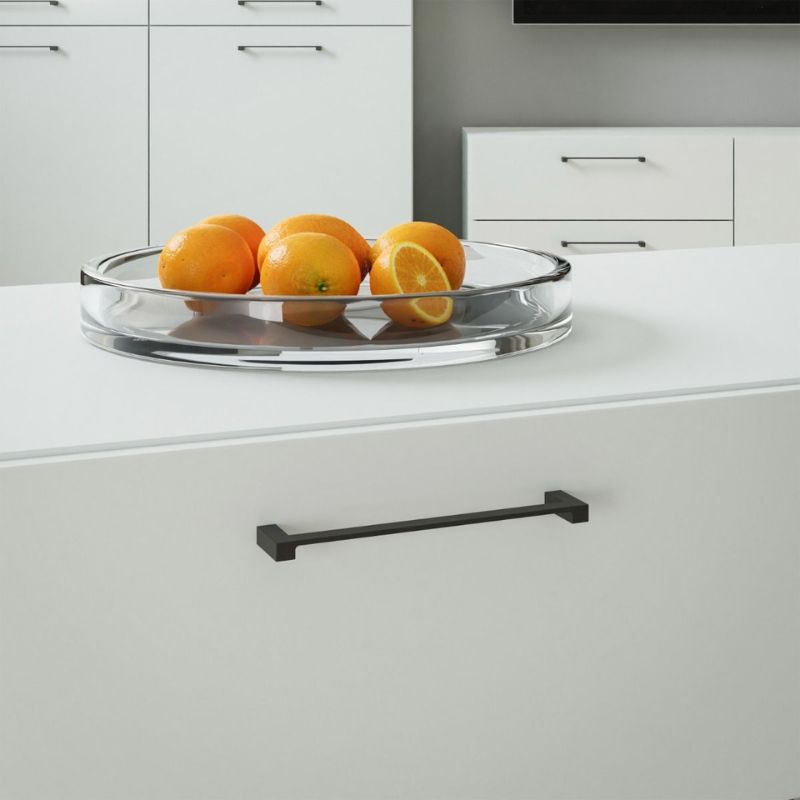 Clear glass tray with oranges on a white kitchen counter