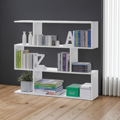 White bookshelf with books and decorative items against a dark wall.