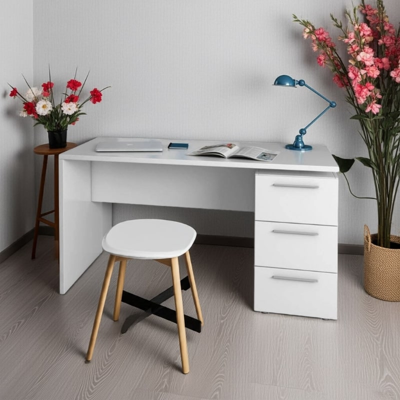 White desk with a chair, flowers, and a lamp in a room setting.