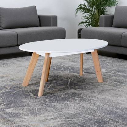 White coffee table with wooden legs in a living room setting