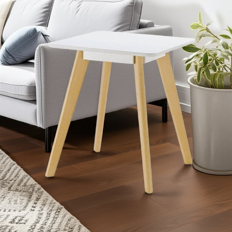 Small white table with wooden legs in a living room setting.