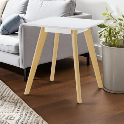 Small white table with wooden legs in a living room setting.