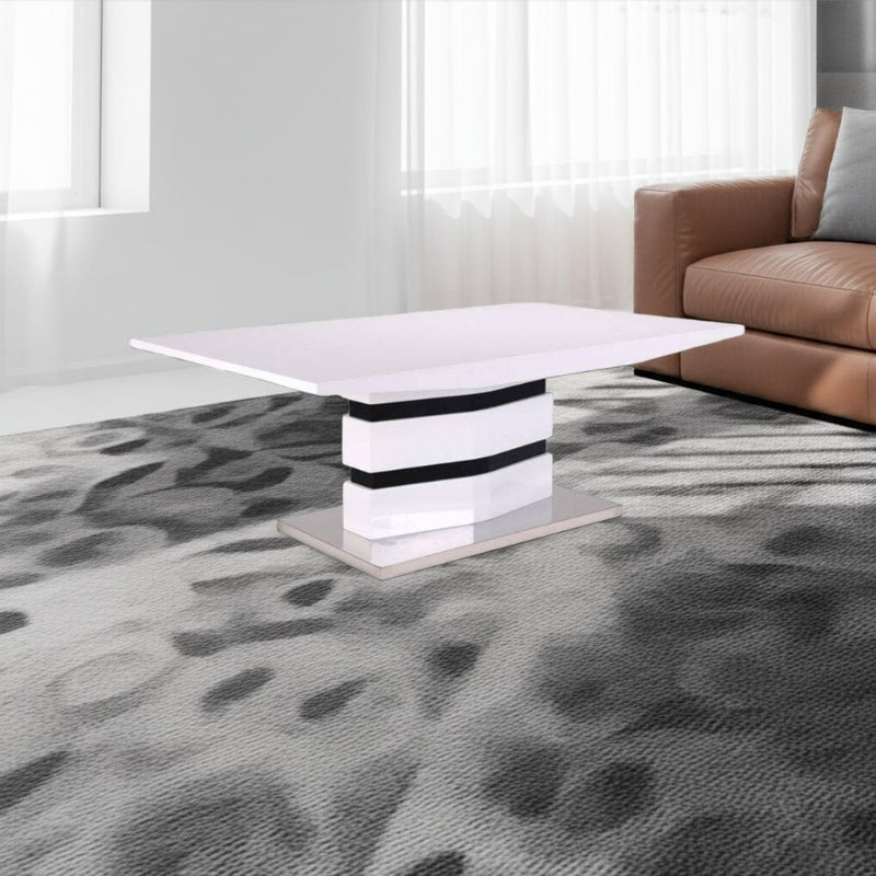 Modern living room with a white coffee table and brown sofa on a patterned gray carpet.