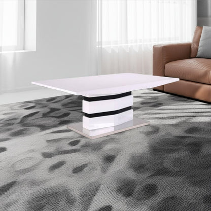 Modern living room with a white coffee table and brown sofa on a patterned gray carpet.