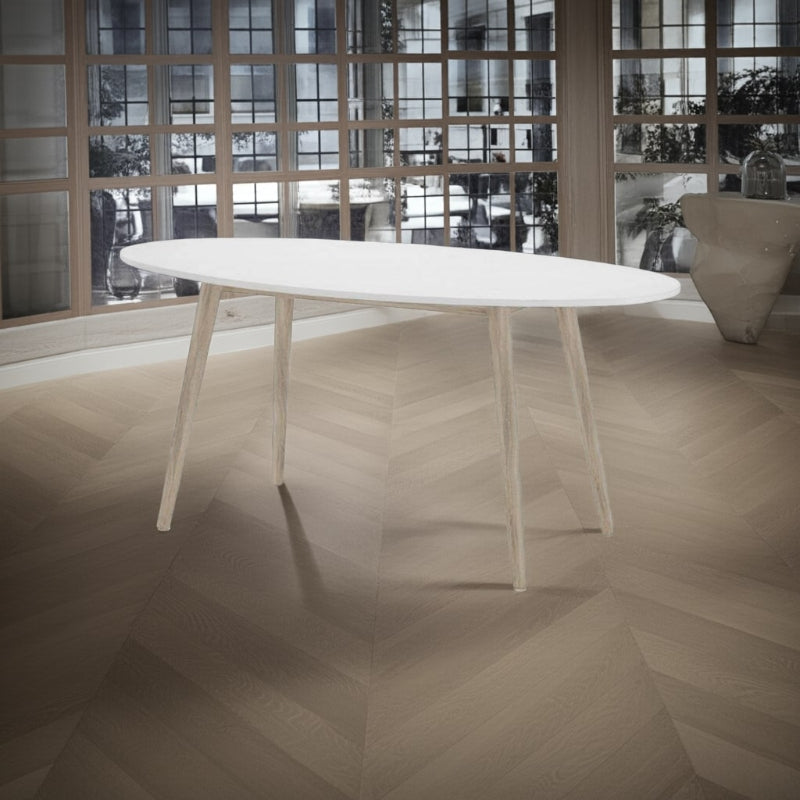 White oval table in a modern room with large windows