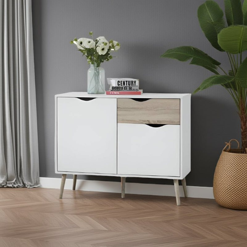 White and wood sideboard with decor items against a gray wall