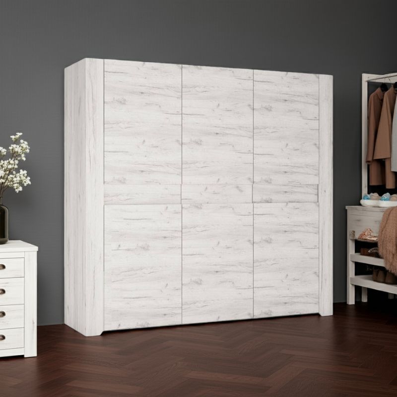White wooden wardrobe in a room with a dark gray wall and wooden floor.