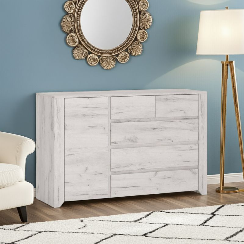 White wooden dresser against a blue wall with decorative mirror and lamp.