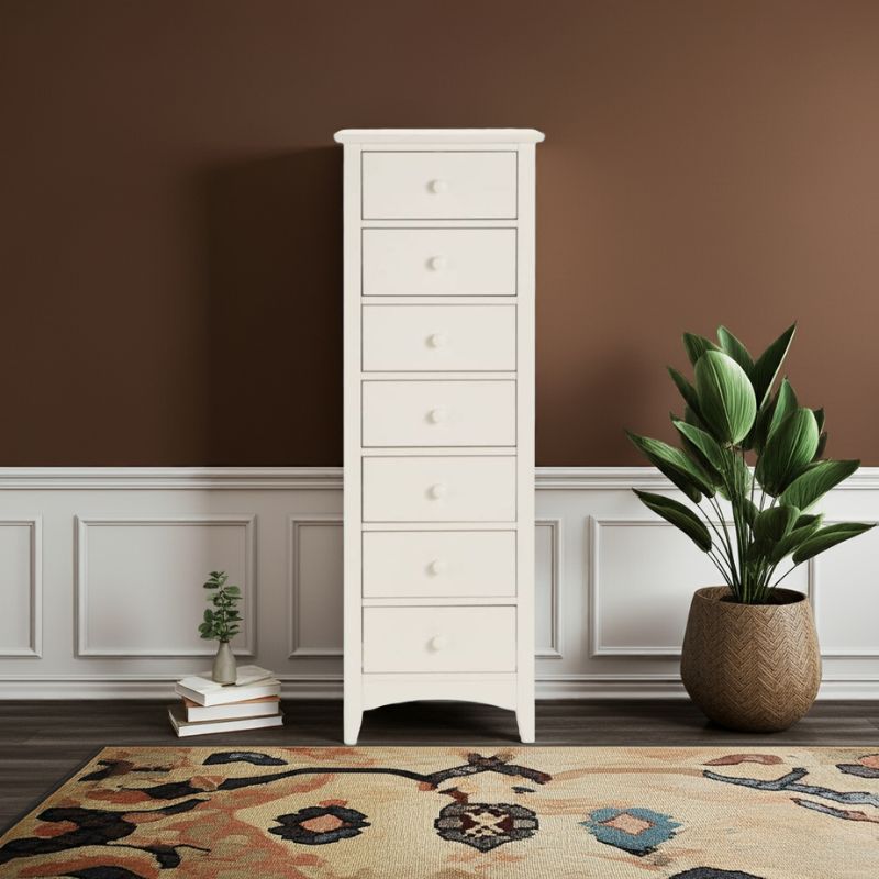 White tall dresser with multiple drawers in a room with a brown wall and decorative rug.