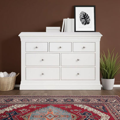 White dresser with decorative items against a brown wall