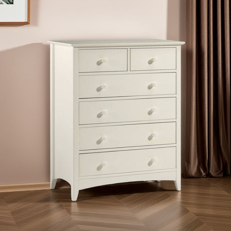 White dresser with multiple drawers in a room with a brown curtain.