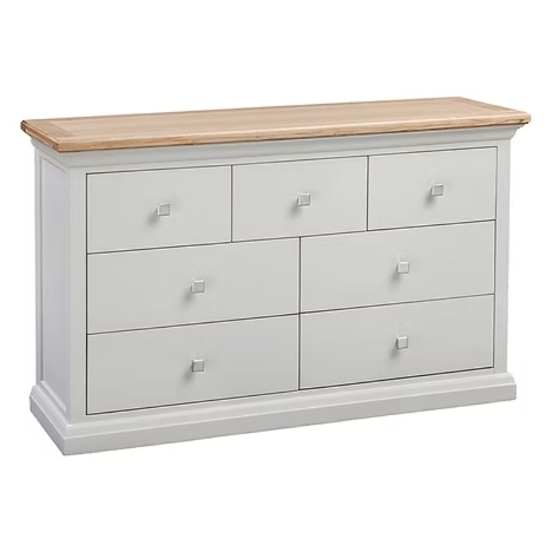 White dresser with six drawers and a wooden top on a white background