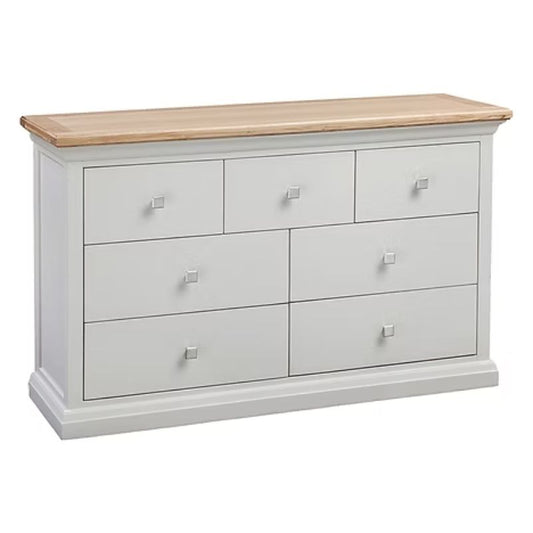 White dresser with six drawers and a wooden top on a white background