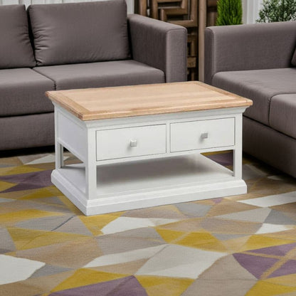 Coffee table with wooden top and white base in a living room setting