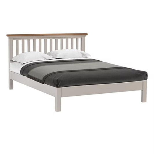 Bed with white frame and wooden headboard on a white background