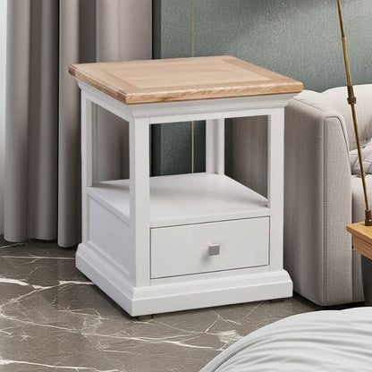 White nightstand with wooden top in a room setting