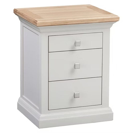 White nightstand with three drawers and a wooden top on a white background