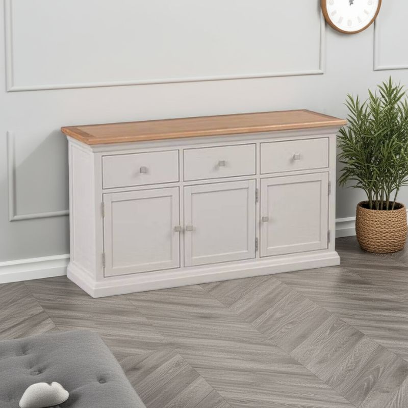 White cabinet with wooden top in a room with gray walls and a plant.