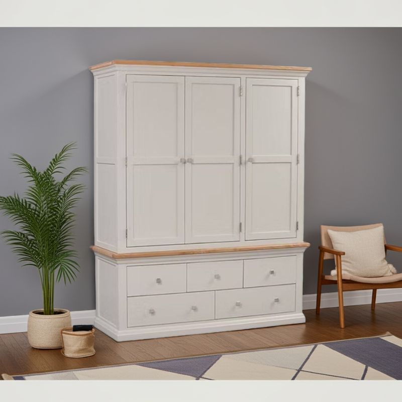 White wardrobe with wooden top and trim in a room with a plant and chair.