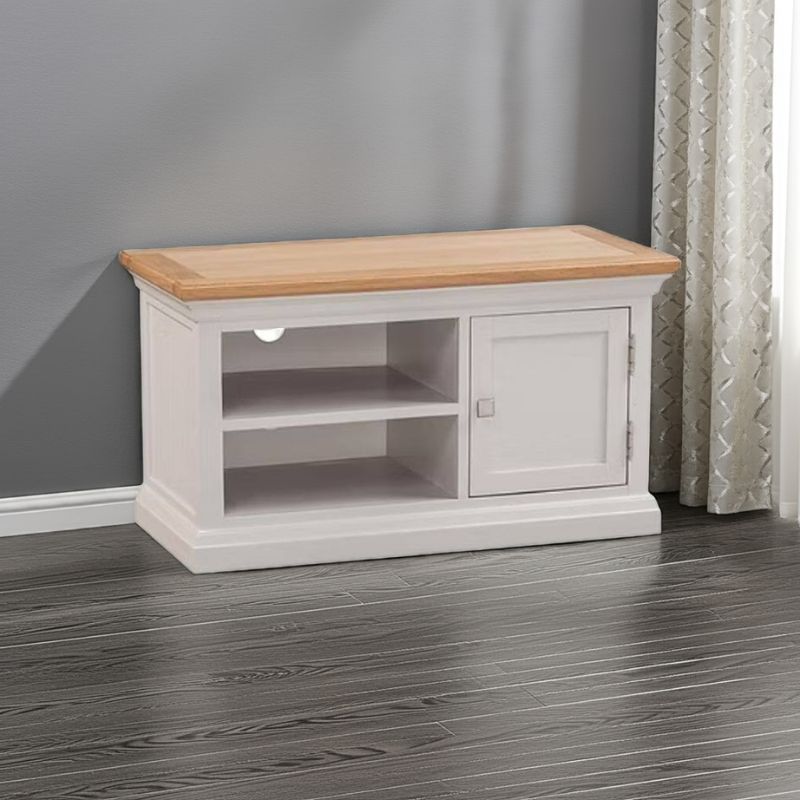 White TV stand with wooden top in a room with gray walls and a curtain.
