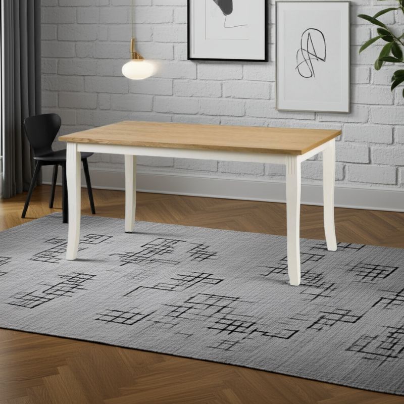 Dining room with a wooden table, black chair, and gray rug on a wooden floor.