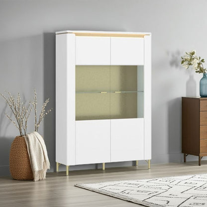White display cabinet with glass doors in a room setting with a rug and plant.