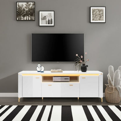Modern living room with a white entertainment console, TV, and decorative items.