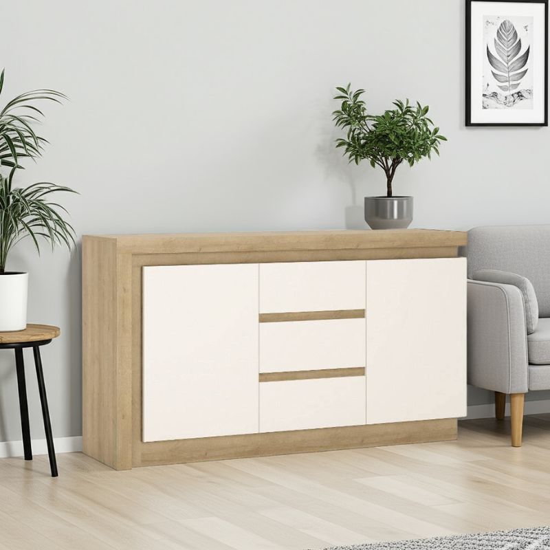 Wooden sideboard with white doors in a living room setting with plants and a sofa.