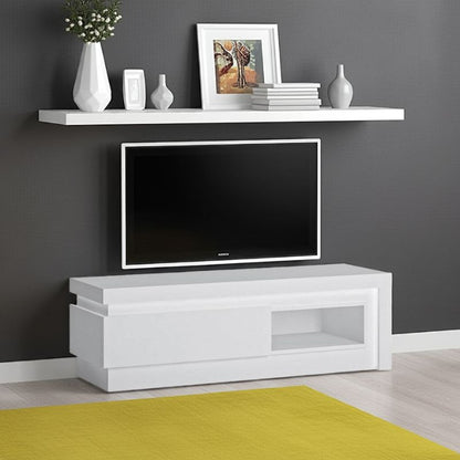 White TV stand with a television, shelf with decorative items, and gray wall.