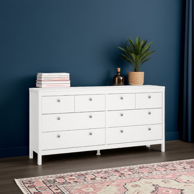 White bedroom dresser with decorative items against a blue wall
