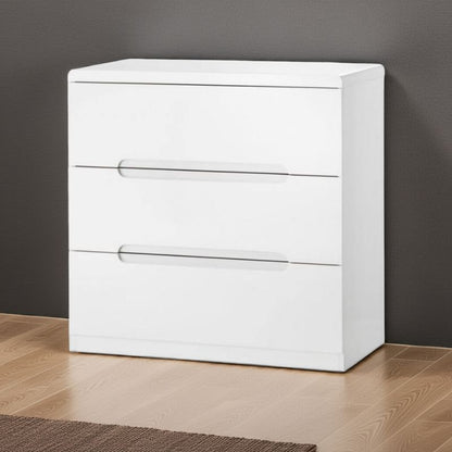 White dresser with three drawers against a dark gray wall.