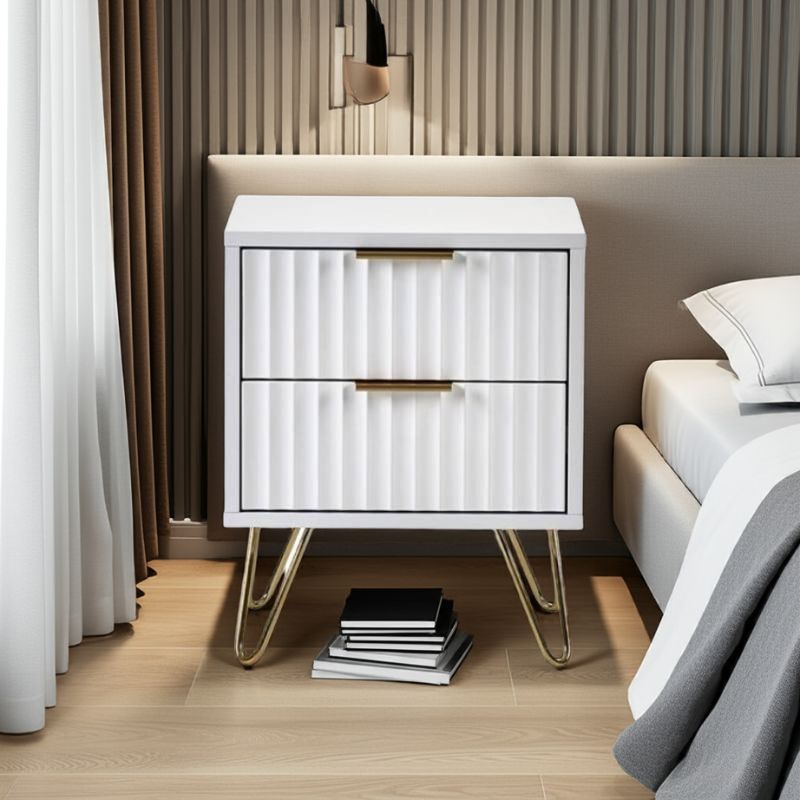 White nightstand with gold legs in a bedroom setting