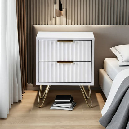 White nightstand with gold legs in a bedroom setting