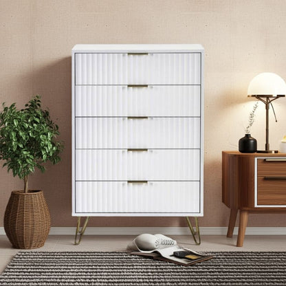 White dresser with gold legs in a room setting with a plant and wooden sideboard.