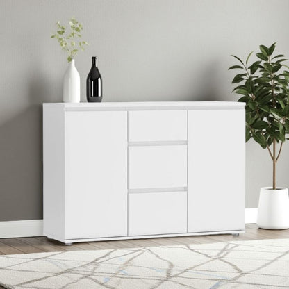 White sideboard with decorative items against a gray wall