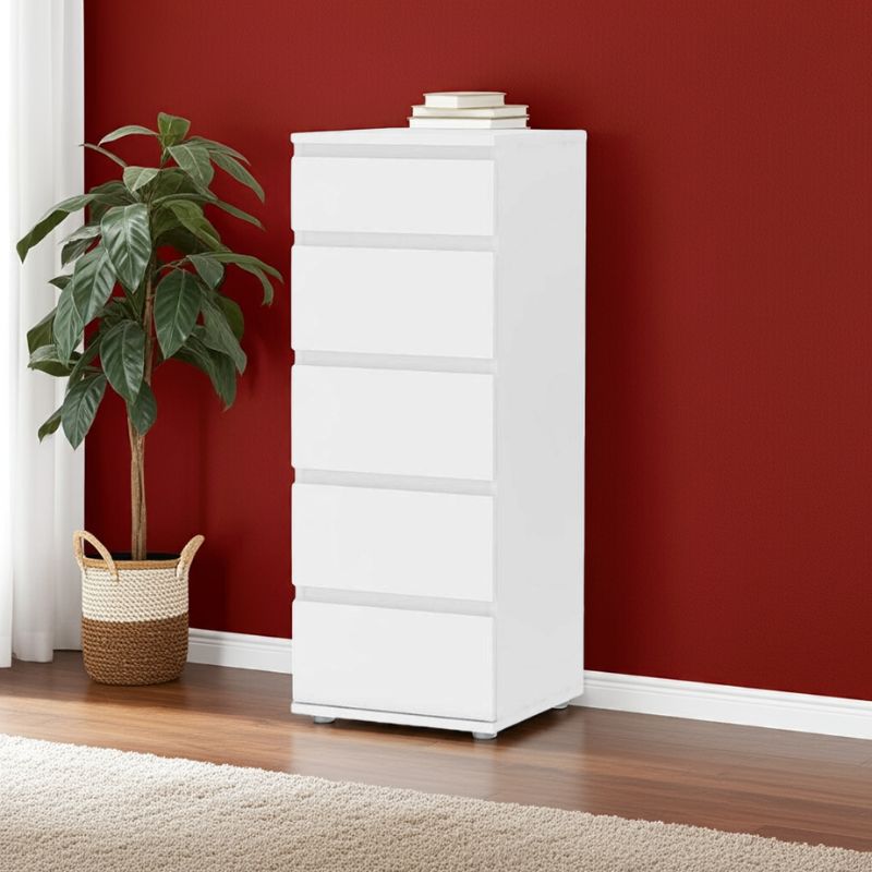 White dresser against a red wall with a plant on a wooden floor