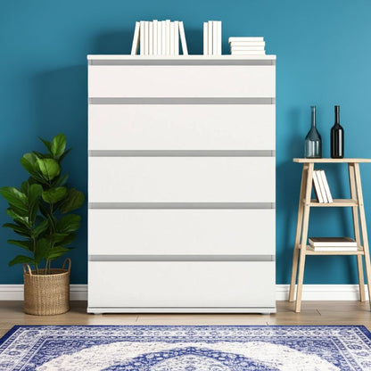 White dresser with 5 drawers against a blue wall with books and plants