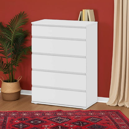 White dresser with books against a red wall with a plant and rug.