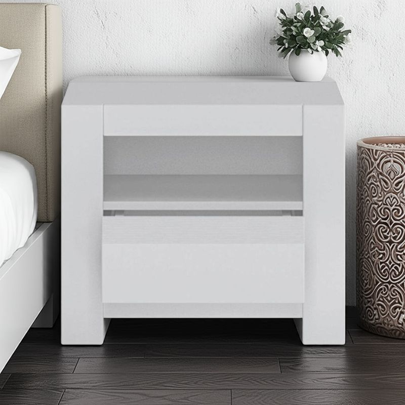 White nightstand with a plant in a bedroom setting