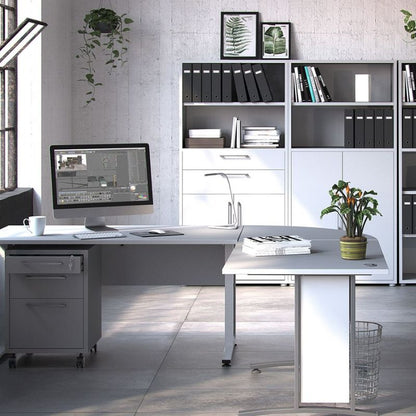 Modern office setup with a desk, computer, and bookshelf.