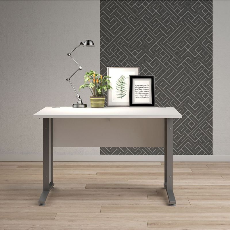 White desk with decorative items against a gray wall with geometric pattern