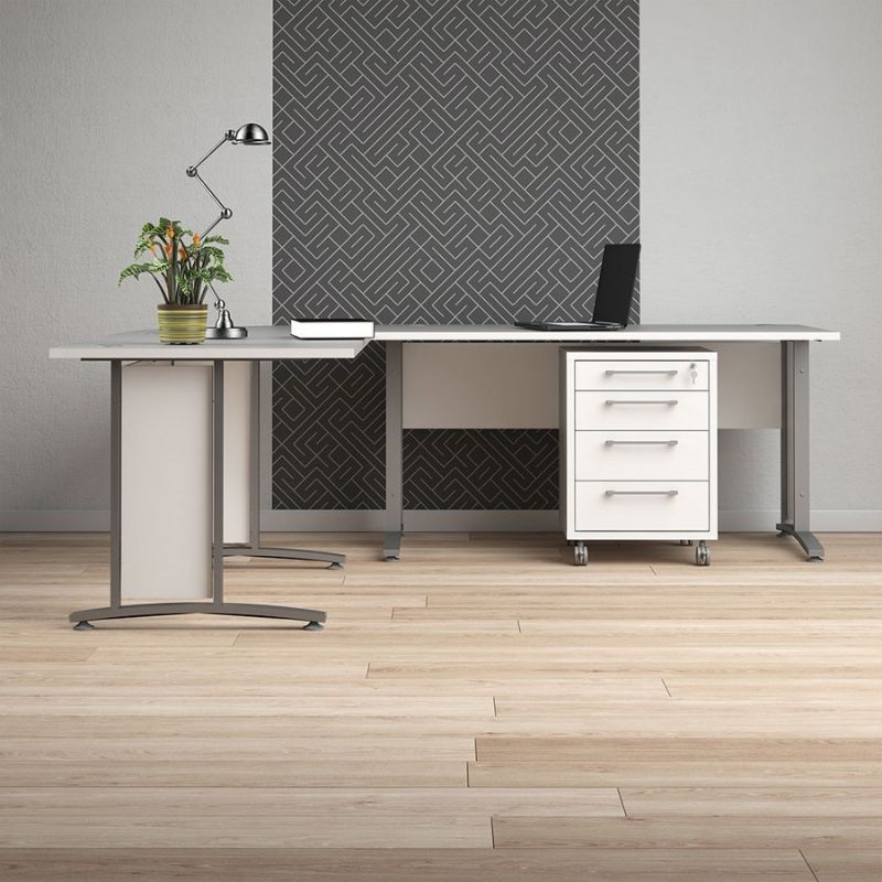 Modern office desk with a plant, lamp, and computer in a room with geometric wall design.