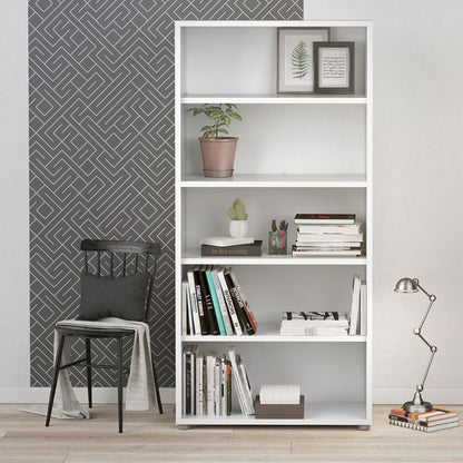 White bookshelf with books and decor items against a geometric-patterned wall.