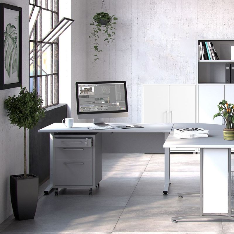 Modern office setup with a desk, computer, and office supplies in a bright room.