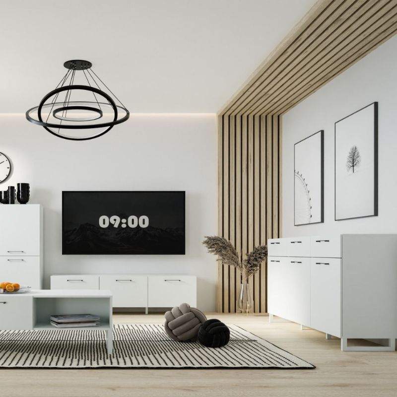 Modern living room with white furniture, a TV displaying the time, and decorative elements.