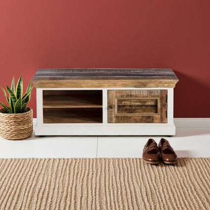 Wooden shoe bench against a red wall with a plant and shoes on a beige rug.