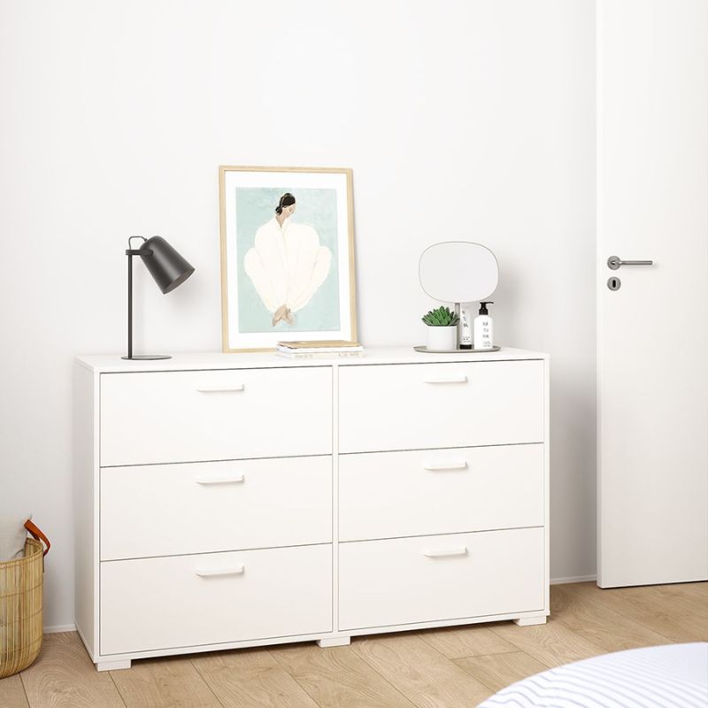 White dresser with decorative items in a room setting