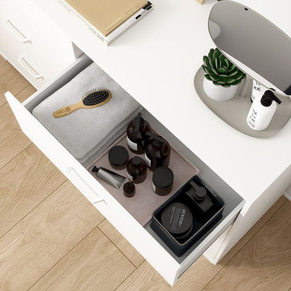 Open drawer with grooming products on a wooden floor
